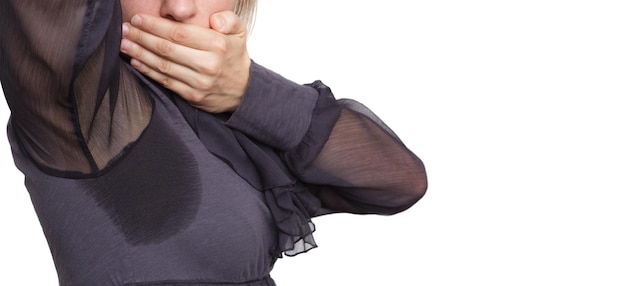 Young woman looking at the sweaty shirt