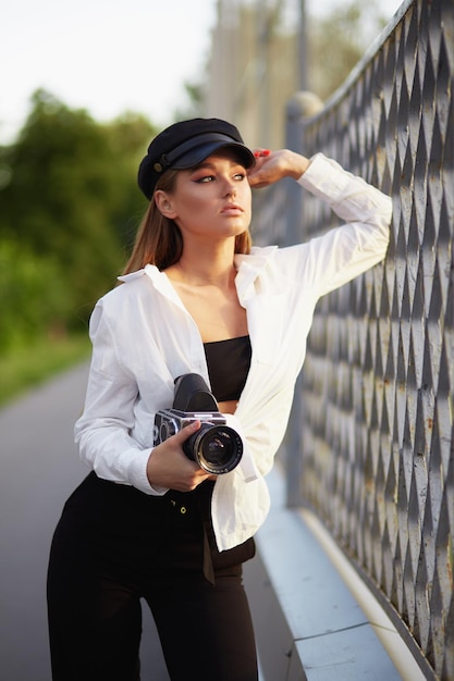 Young woman looking through camera lens