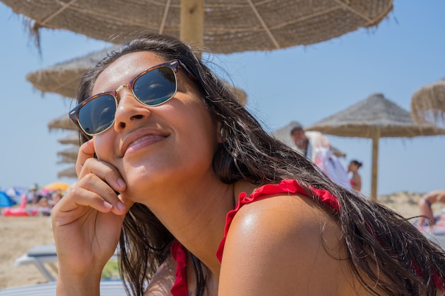 Young woman looking up on the beach