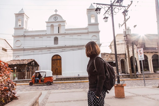 A young woman looking at the white church of Copan Ruinas Honduras