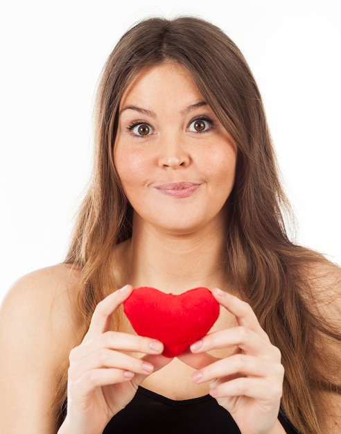 Young woman in love with a heart in hand