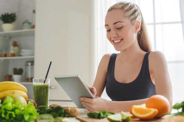 Young woman making detox smoothie at home