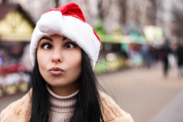 Young woman making faces at winter fair market