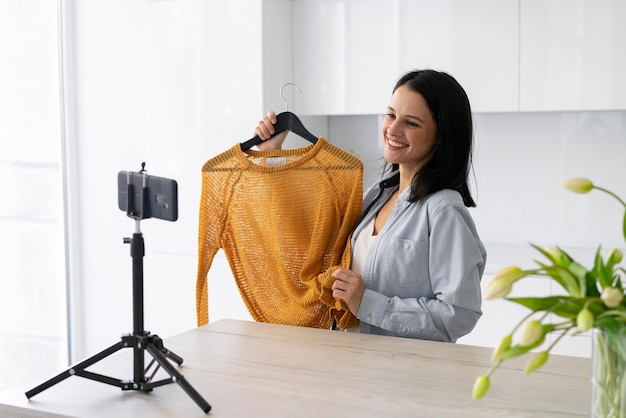 Young woman making a vlog at home with her phone