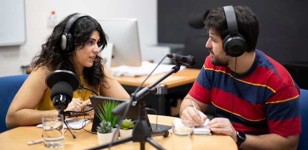 Young woman and man broadcasting a live podcast or radio show