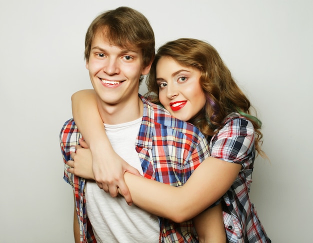 Young woman and man wearing casual wear over grey.