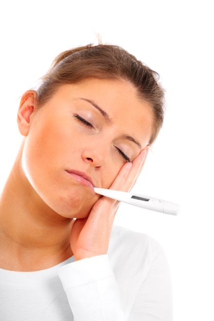 young woman measuring temperature over white background