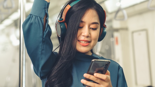 Young woman mobile phone on public train