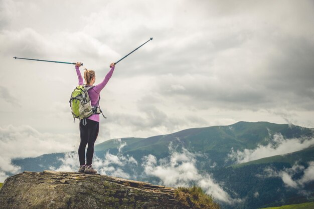 Young woman n the top of the mountains