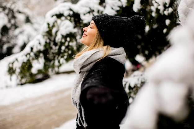 Young woman n warm clothes enjoying in snow