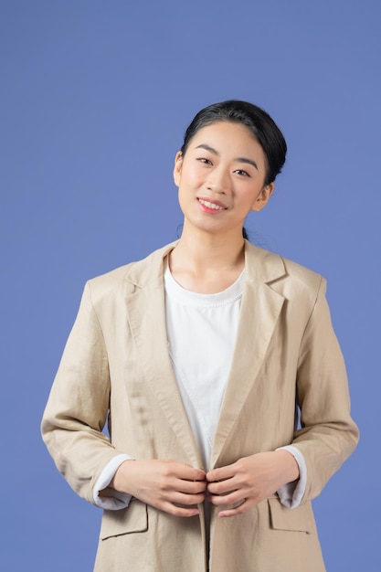 Young woman news commentator with crossed arms looking away isolated on purple