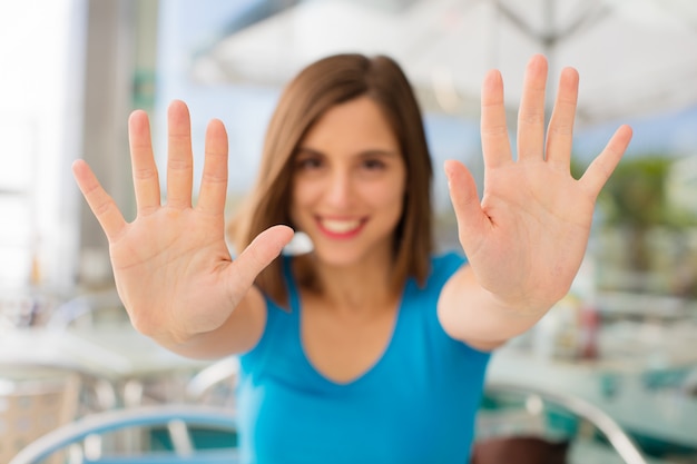 young woman number ten sign against company background