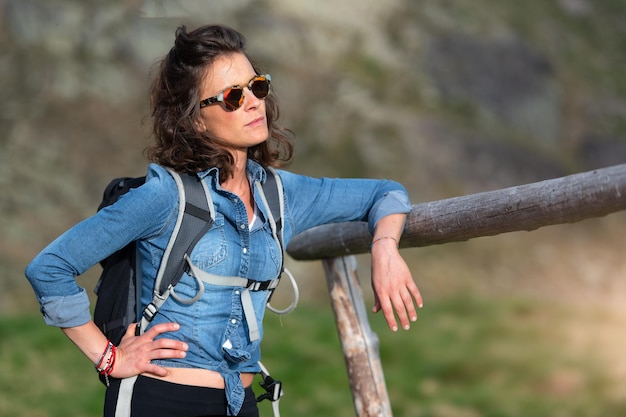 Young woman observes the panorama during a nature hike