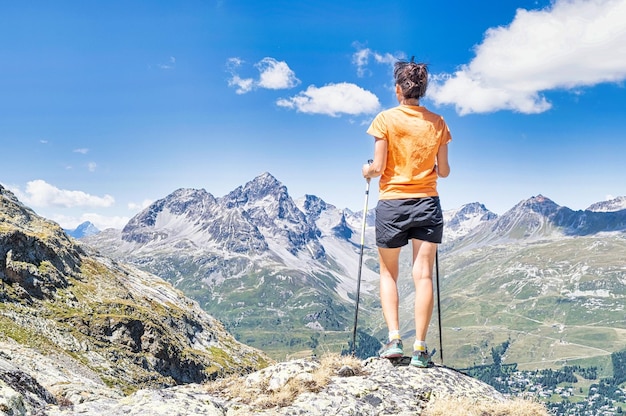 A young woman observes the view in the mountains