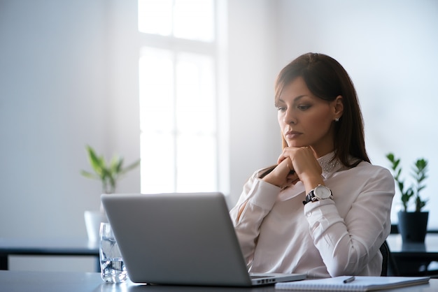 Young woman in the office working with a laptop