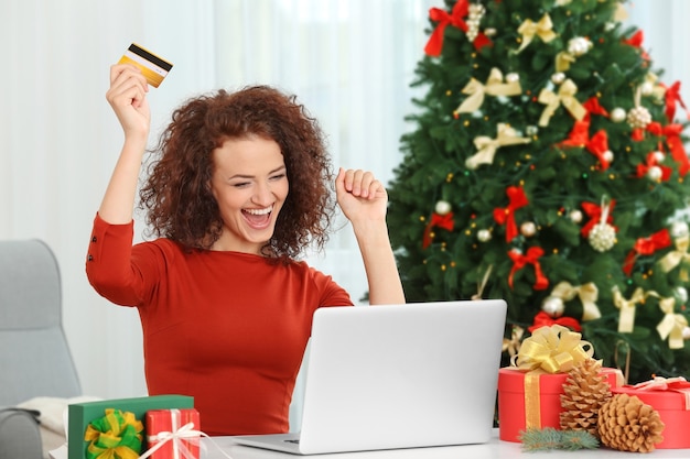 Young woman ordering Christmas gifts online