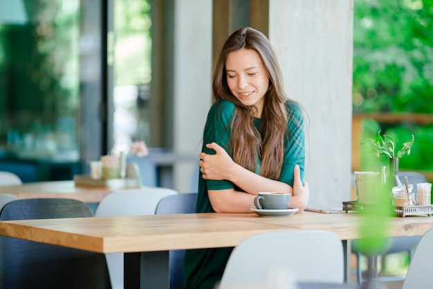 Young woman in outdoor cafe