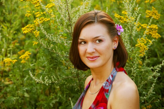 Young woman outdoor in the grass in summertime