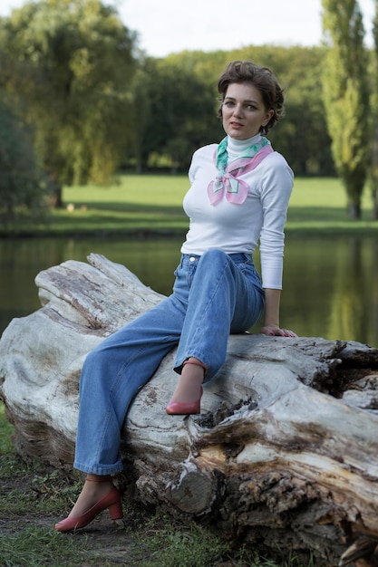 Young woman in the park Cute girl portrait in french style