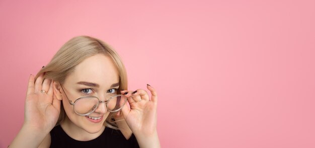 Young woman on pink background, copyspace