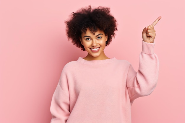 A young woman in a pink sweater points to the sky.