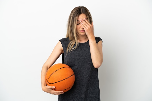 Young woman playing basketball over isolated white wall with tired and sick expression