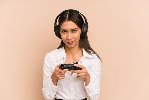 Young woman playing a videogame with a game controller isolated