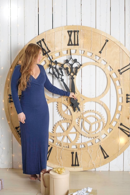 Young woman plus size model near Christmas tree