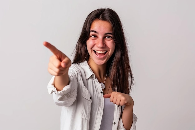 Young woman pointing front with happy expression on white isolated background