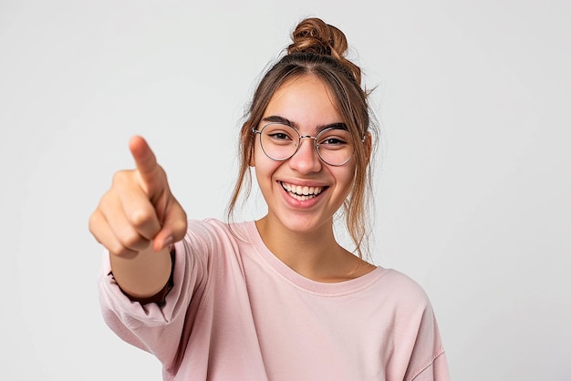 Young woman pointing front with happy expression on white isolated background