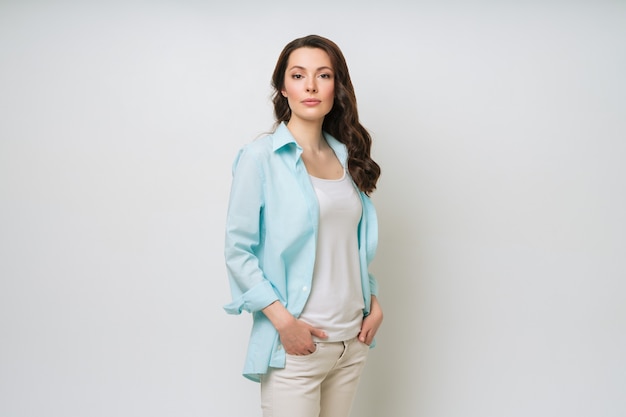 Young woman portrait adorable brunette in a sweater looking at the camera with her arms crossed