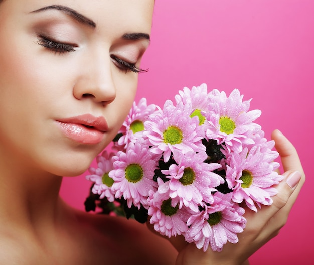 Young woman portrait with pink chrysanthemum