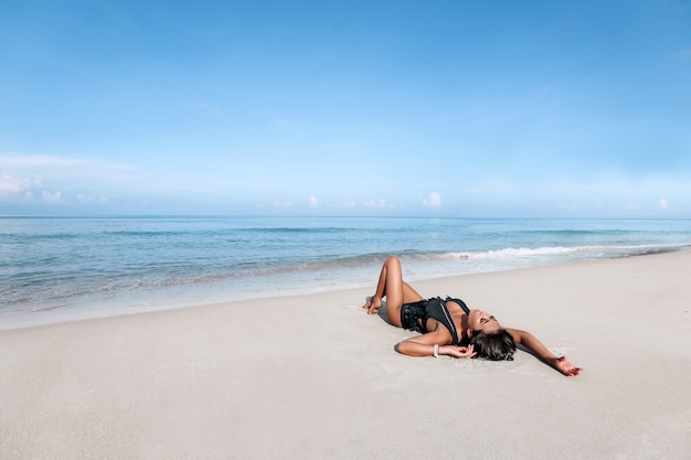 Young woman posing on a beach