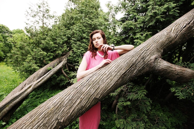 Young woman posing on a tree