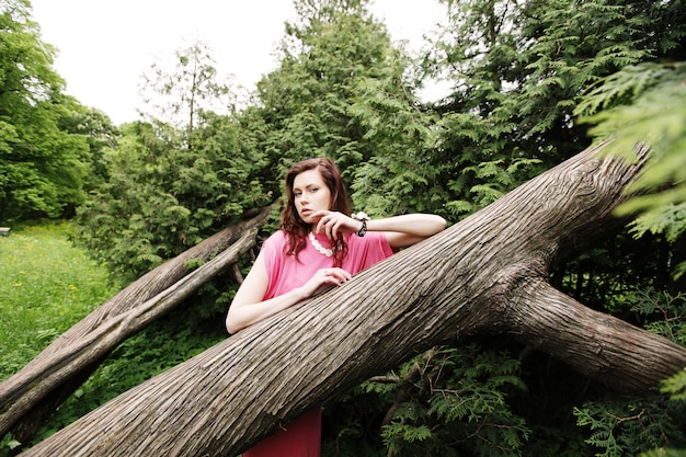 Young woman posing on a tree