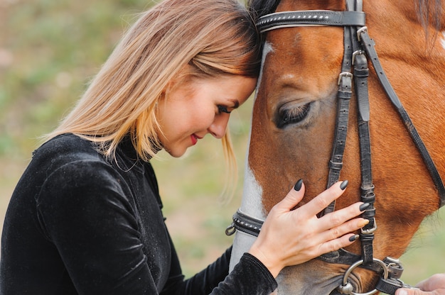 Young woman posing with a horse