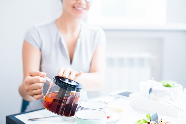 Young Woman Pouring Tea