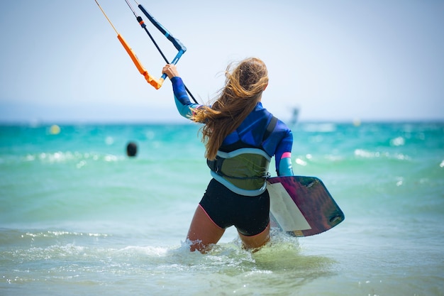 young woman practicing kite surfing