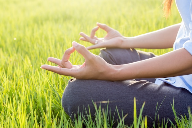 Young woman practicing yoga(yoga lotus meditation); Lotus Yoga.