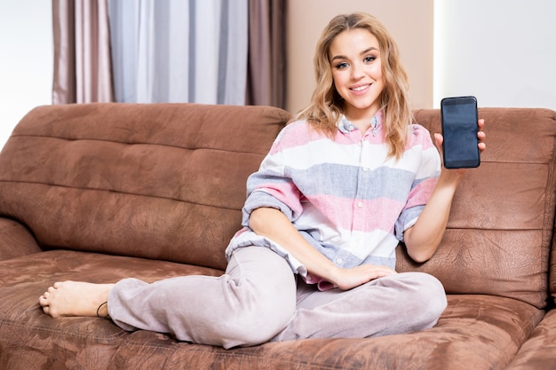 Young Woman Presenting Mobile Phone