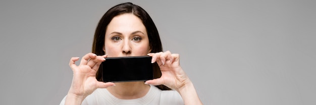 Young woman presenting telephone