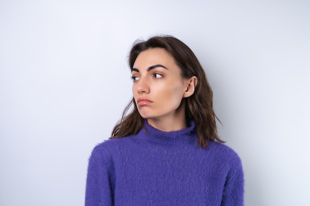 Young woman in purple soft cozy sweater in the background upset