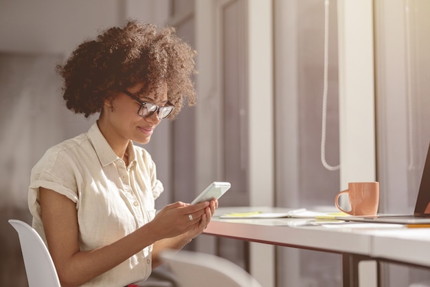 Young woman reading the message on her mobile phone