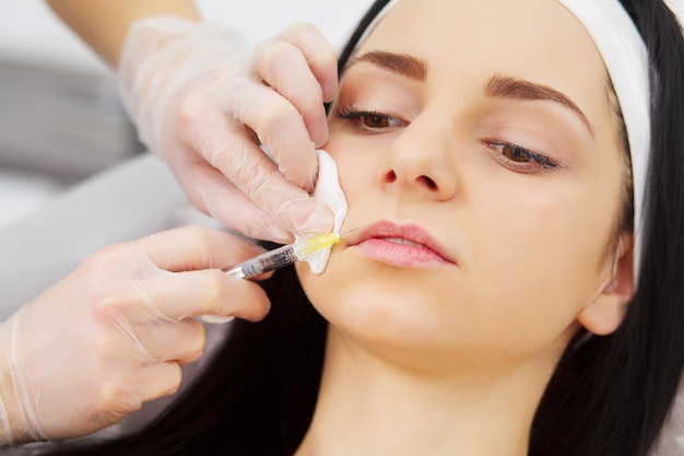 Young woman receiving an injection of hyaluronic acid