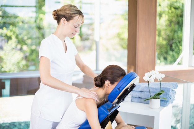 Young woman receiving shoulder massage