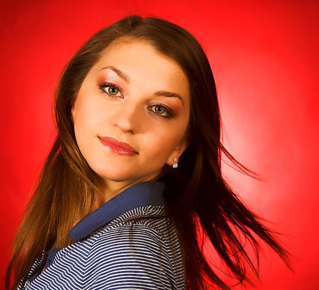 Young woman over red background