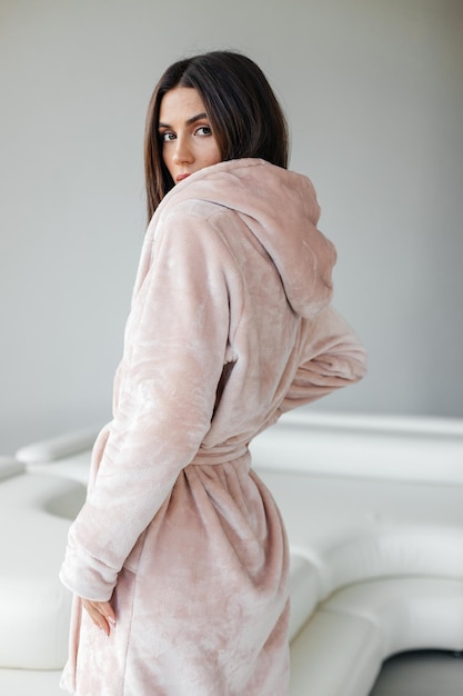 Young woman relaxing in bathrobe and spa towel after having bath shower treatment rest and body care