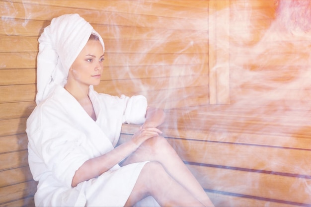 Young woman relaxing in a sauna