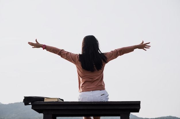 Young woman relaxing in summer  on moutain background . People freedom style.