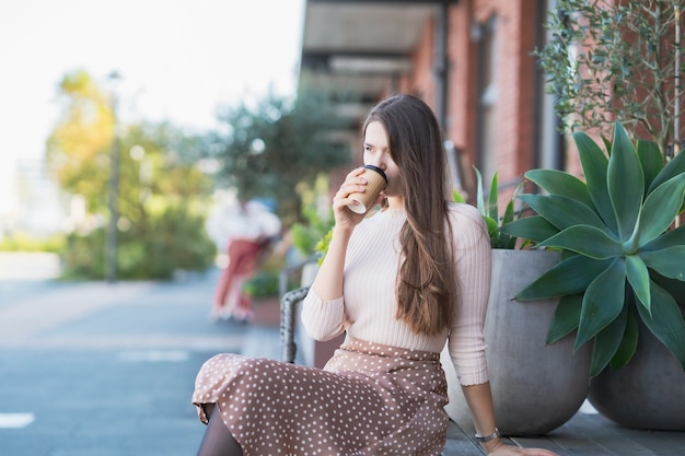 Young woman relaxing with a coffee cup in her hand